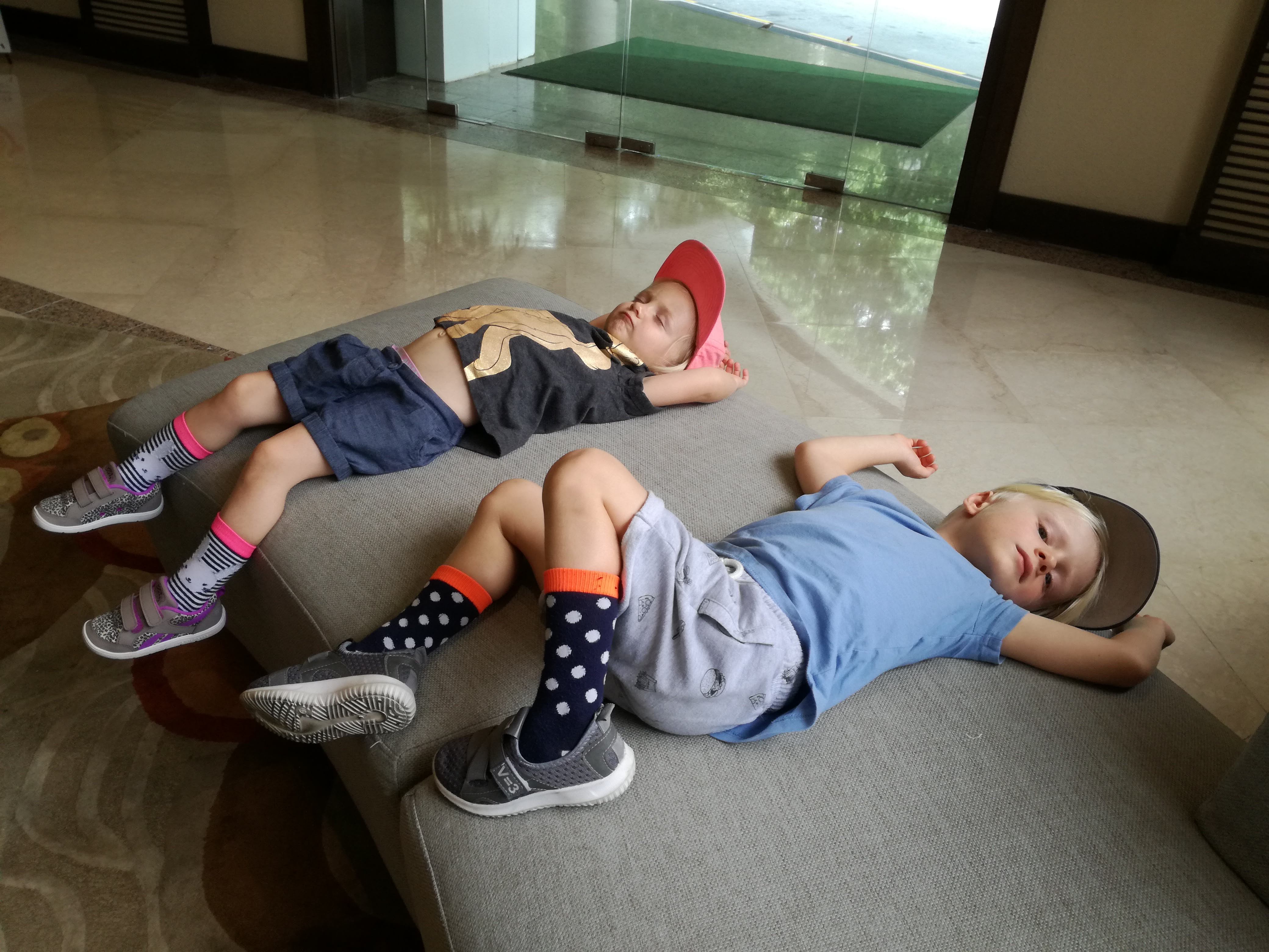Kids waiting on hotel room couch